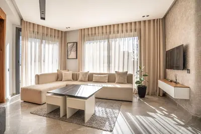 a living room with a couch and a table at Central, confort & luxueux 1room - quartier Princesses in Casablanca