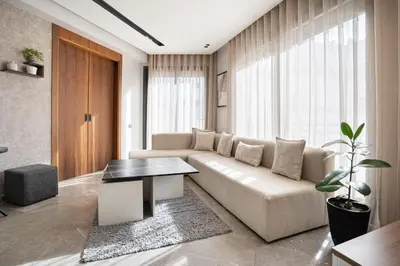 a living room with a couch and a table at Central, confort & luxueux 1room - quartier Princesses in Casablanca