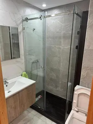 a bathroom with a shower and a sink and a toilet at appartement Sf in Casablanca