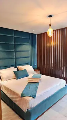 a large bed with a blue headboard in a bedroom at L'harmonie in Casablanca