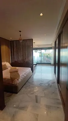 a bedroom with a bed and a large window at L'harmonie in Casablanca