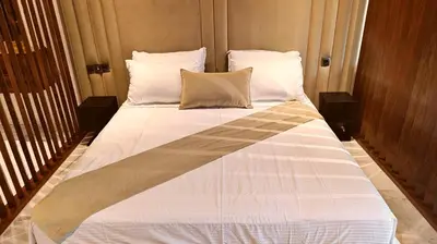 a large bed with white sheets and pillows at L'harmonie in Casablanca