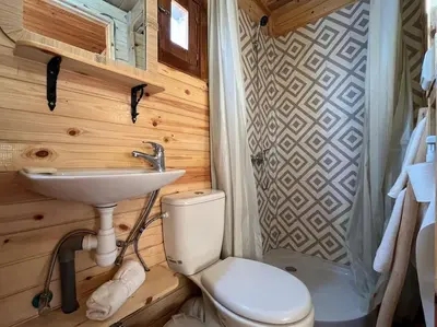 a bathroom with a toilet and a sink at Countryside's Tiny House in O Ben Slimane