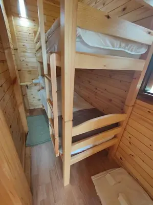 an empty bunk bed in a wooden cabin at Countryside's Tiny House in O Ben Slimane