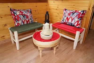 a living room with two chairs and a table with a table at Countryside's Tiny House in O Ben Slimane