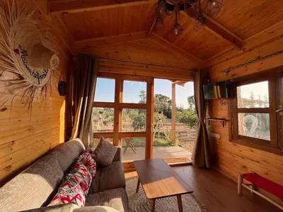 a living room with a couch and a table at Countryside's Tiny House in O Ben Slimane
