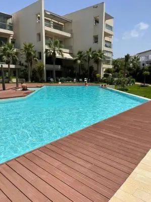 a large blue swimming pool in front of a building at Rock Island Haut standing in Mohammedia