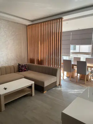 a living room with a couch and a table at Rock Island Haut standing in Mohammedia