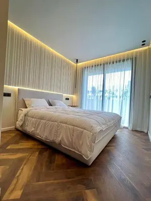 a bedroom with a large bed and a large window at Studio prague in Casablanca