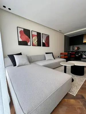 a living room with a couch and a table at Studio prague in Casablanca