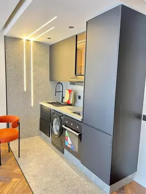 a kitchen with a stove and a washing machine at Studio prague in Casablanca