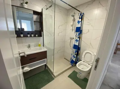 a bathroom with a shower and a toilet and a sink at Apparemment Meuble a 5 min de l'aéroport casa in Nouaceur