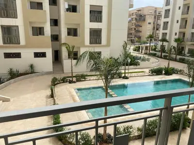 an apartment with a swimming pool in a building at Apparemment Meuble a 5 min de l'aéroport casa in Nouaceur