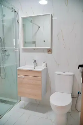 a bathroom with a toilet and a sink and a shower at Les portes de Temara in Temara