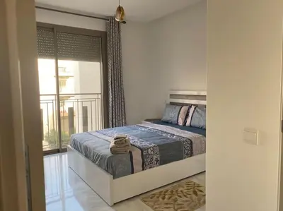 a bedroom with a bed and a window at Studio Meuble a 5 min de l'aéroport Casablanca in Nouaceur