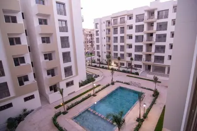 an overhead view of a swimming pool between two buildings at Studio Meuble a 5 min de l'aéroport Casablanca in Nouaceur
