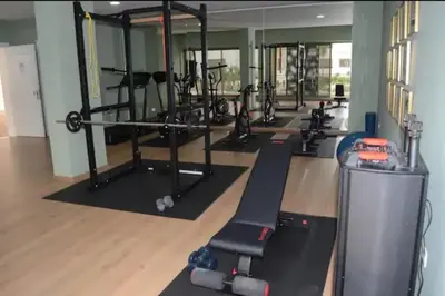 a gym with a row of treadmills and machines at Studio Meuble a 5 min de l'aéroport Casablanca in Nouaceur