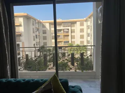 a living room with a view of a building from a window at Studio Meuble a 5 min de l'aéroport Casablanca in Nouaceur