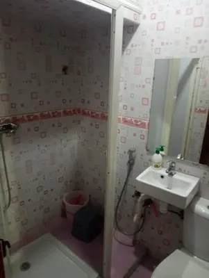 a small bathroom with a sink and a shower at Appartement à Bernoussi Casablanca in Casablanca