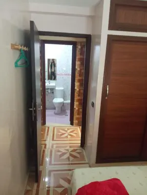 a hallway with a bathroom with a toilet and a door at Appartement à Bernoussi Casablanca in Casablanca