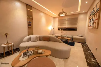 a living room with a large couch and a table at Luxury Suite Mannesmann - Seaview in Mohammedia