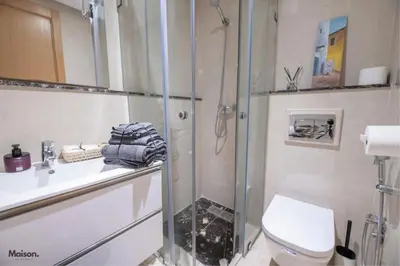 a bathroom with a shower and a toilet and a sink at Luxury Suite Mannesmann - Seaview in Mohammedia