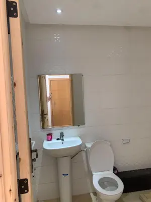 a bathroom with a toilet and a sink at Résidence Perla Andalusia Vue Sur Mer in Mansouria