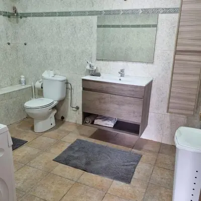 a bathroom with a toilet and a sink and a mirror at Appartement lumineux by Moon in Casablanca