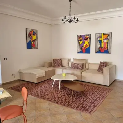 a living room with a couch and a table at Appartement lumineux by Moon in Casablanca