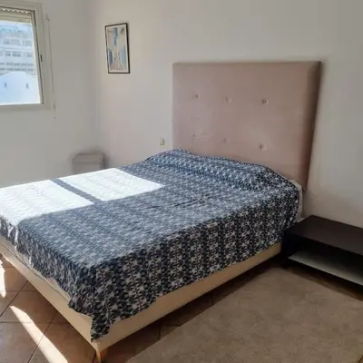 a bedroom with a bed in the corner of a room at Appartement lumineux by Moon in Casablanca