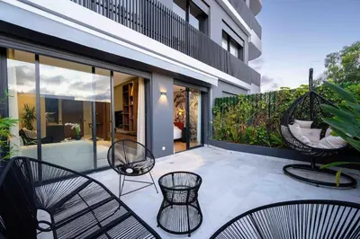an outdoor patio with chairs and a swing at Luxe Modern Studio in Casablanca in Casablanca