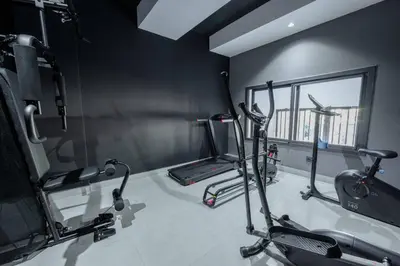 a gym with three exercise bikes and a mirror at Luxe Modern Studio in Casablanca in Casablanca