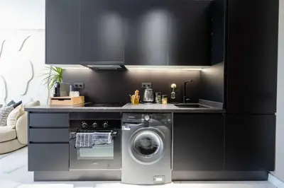 a kitchen with a washing machine and a stove at Luxe Modern Studio in Casablanca in Casablanca