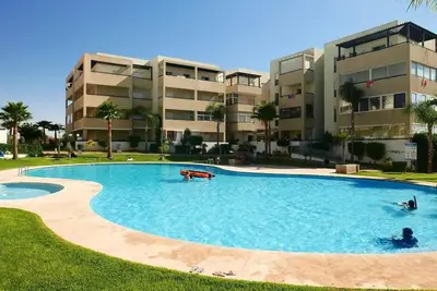 a large swimming pool in front of a building at Appartement Haut Standing - Bouznika plage in Bouznika