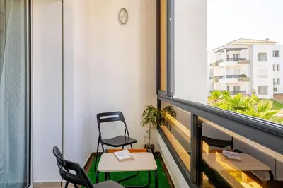 a balcony with a table and chairs and a window at New! Appartement les pieds dans l'eau WELCOME STAY in Pont Blondin