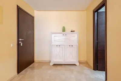 a white cabinet in a room with a door at New! Appartement les pieds dans l'eau WELCOME STAY in Pont Blondin