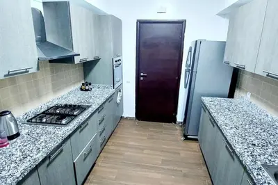 a kitchen with a stove and a refrigerator at New! Appartement les pieds dans l'eau WELCOME STAY in Pont Blondin