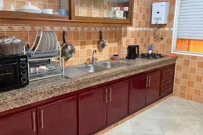 a kitchen with a sink and a microwave at Spacious & Comfy Moroccan Apartment in Temara