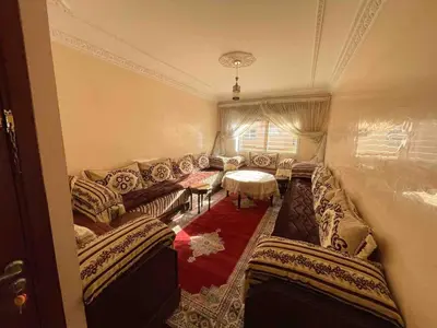 a living room with a couch and a table at Spacious & Comfy Moroccan Apartment in Temara