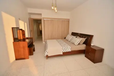 a bedroom with a bed with a dresser and a drawer at Spacious Haven in Abdelmoumen in Casablanca