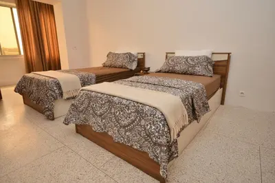 a bedroom with two beds with blankets and pillows at Spacious Haven in Abdelmoumen in Casablanca