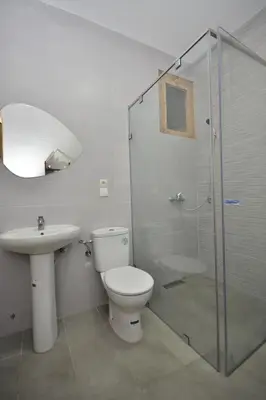 a bathroom with a toilet and a sink and a shower at Spacious Haven in Abdelmoumen in Casablanca