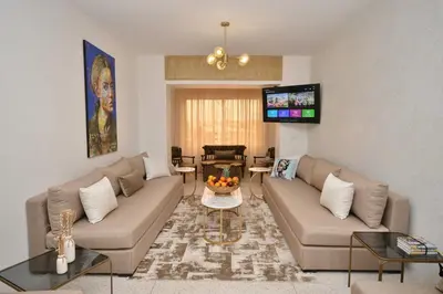 a living room with two couches and a tv at Spacious Haven in Abdelmoumen in Casablanca