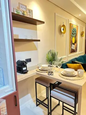 a kitchen with a table with plates on it at Stylish Appartement Lumineux et Luxueux Au Coeur De Maarif Quartier Palmier Près De Station Tramway & Bd Abdelmoumen Casablanca in Casablanca