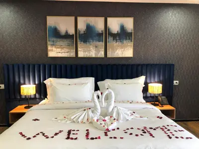a bedroom with two swans made out of flowers on a bed at Hôtel Hariz Son in Berrechid