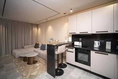 a kitchen with a living room with a couch at Luxury Studio in Luxury Place in Casablanca