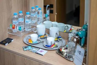 a counter with cups and plates and bottles of water at Luxury Studio in Luxury Place in Casablanca