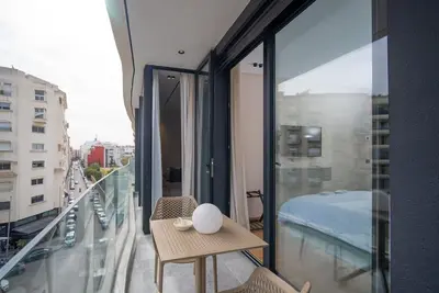 a room with a balcony with a bed and a table at Luxury Studio in Luxury Place in Casablanca