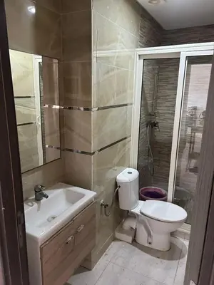 a bathroom with a toilet and a sink and a shower at Appartement à Sidi Rahal - 5 min de la plage in Sidi Rahal