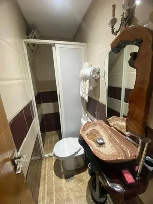 a bathroom with a wooden sink and a toilet at Un écrin rabati in Rabat